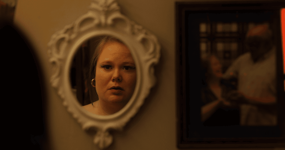 Woman looking into a mirror.