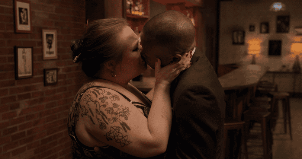 A woman and a man passionately kissing.