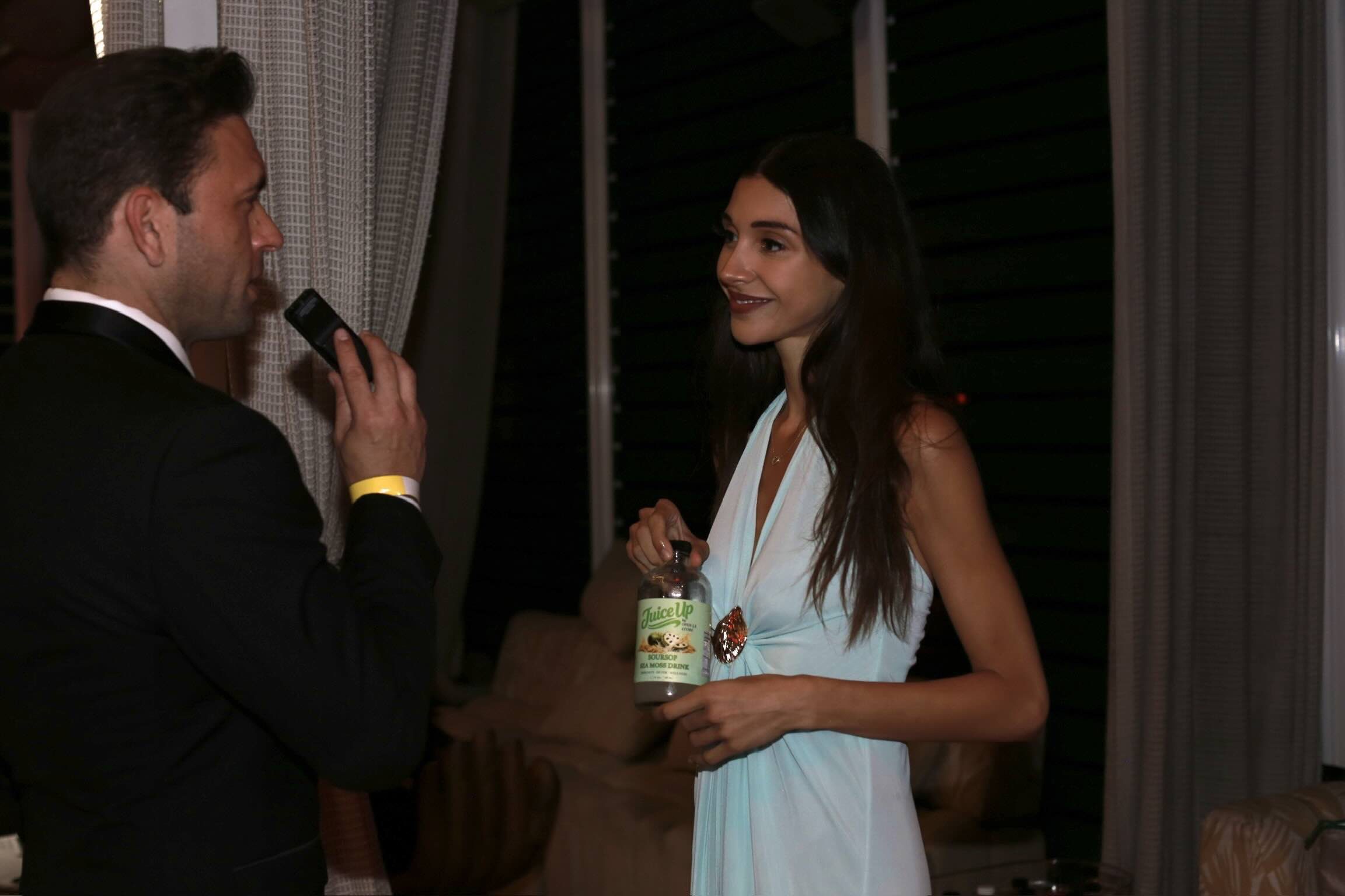 Athena of Open Store LA speaks with Cameron Knight of The Hollywood Times during the Emmy Awards after-party at Level 8. Photo by Lan Bui