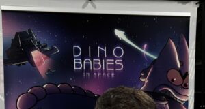 Across the table: where fandom becomes community at Long Beach Comic Con Matt Bolinger holding Dino Babies in Space