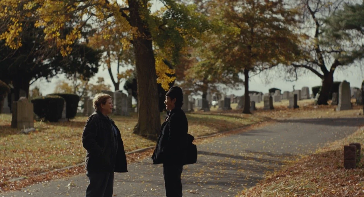 two people at a cemetery.