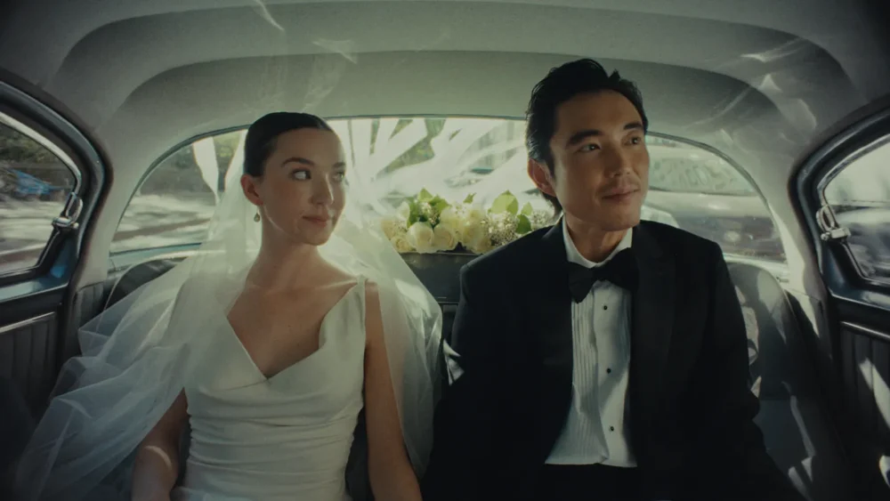 A bride and groom in a car.